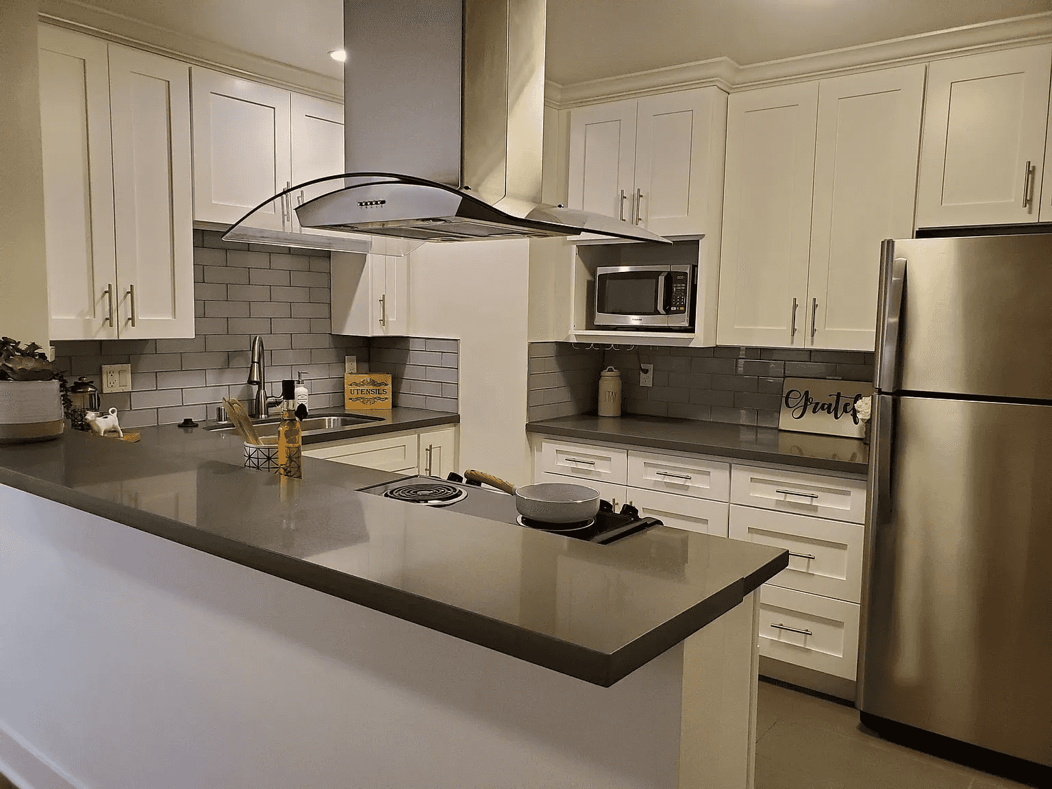 kitchen view with shaker cabinets and tile backsplash
