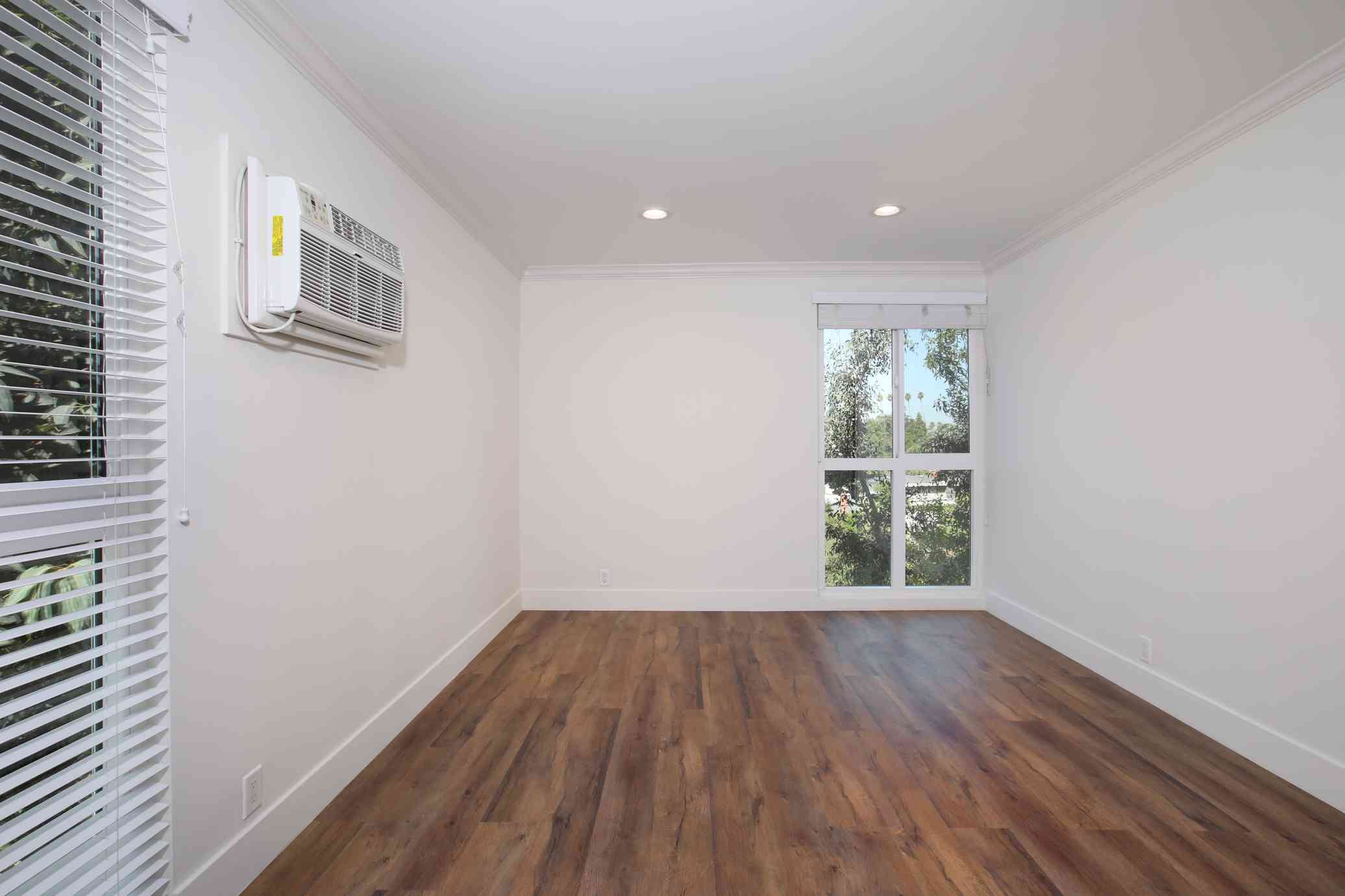 bright bedroom with recessed lighting and ac